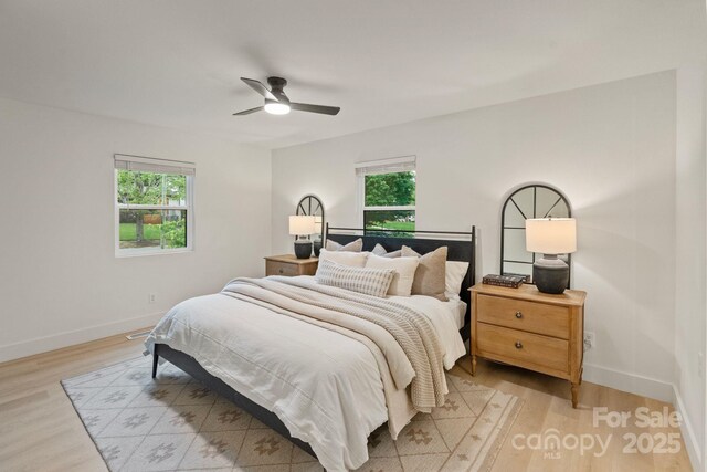 3326 Winterfield Pl, Charlotte, NC 28205 - bedroom featuring multiple windows, light wood-type flooring, and baseboards