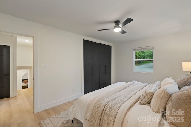 3326 Winterfield Pl, Charlotte, NC 28205 - bedroom with light wood-style floors, a ceiling fan, and baseboards