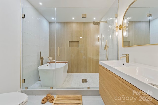 3326 Winterfield Pl, Charlotte, NC 28205 - bathroom featuring a shower stall, vanity, a freestanding tub, and recessed lighting