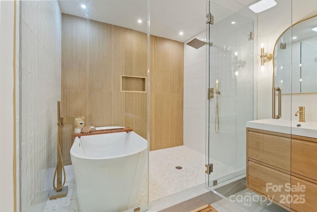 3326 Winterfield Pl, Charlotte, NC 28205 - bathroom with a stall shower, tile walls, a freestanding bath, and vanity