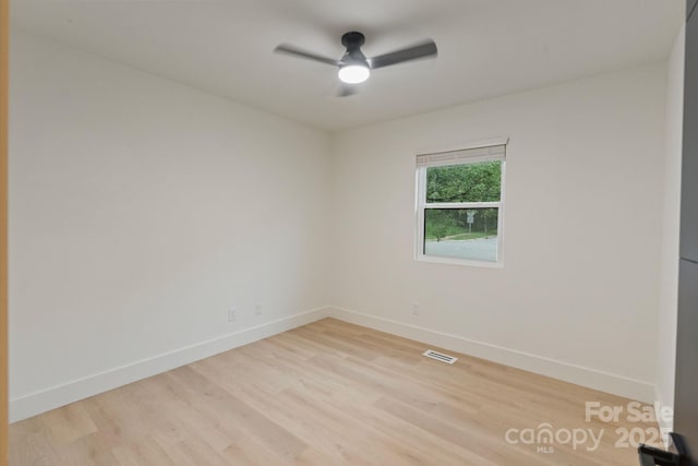 3326 Winterfield Pl, Charlotte, NC 28205 - empty room featuring a ceiling fan and light wood-style floors