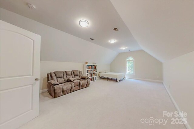 118 Tayport Dr, Troutman, NC 28166 - living area featuring lofted ceiling, carpet floors, and baseboards