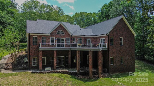 118 Tayport Dr, Troutman, NC 28166 - back of house with a yard, a wooden deck, brick siding, and a patio area
