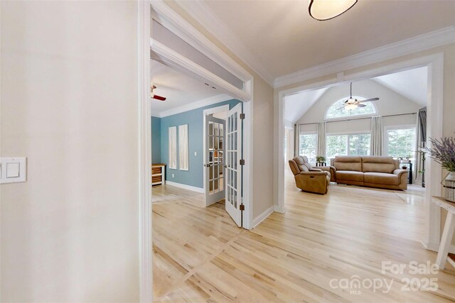 118 Tayport Dr, Troutman, NC 28166 - hallway with ornamental molding, french doors, light wood-style flooring, baseboards, and vaulted ceiling