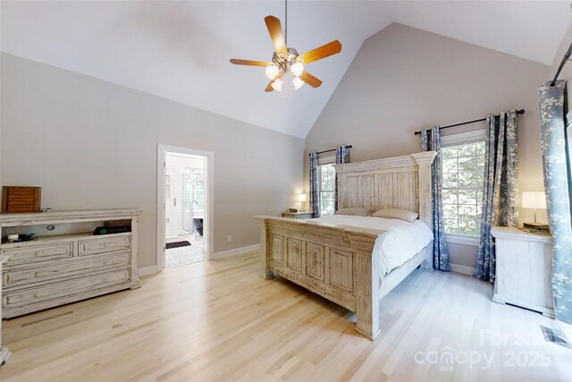 118 Tayport Dr, Troutman, NC 28166 - bedroom with high vaulted ceiling, light wood finished floors, baseboards, and ensuite bath