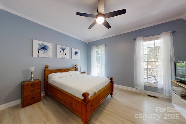 118 Tayport Dr, Troutman, NC 28166 - bedroom featuring ornamental molding, multiple windows, light wood-style floors, baseboards, and a ceiling fan