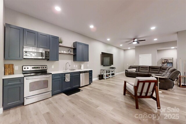 118 Tayport Dr, Troutman, NC 28166 - kitchen featuring stainless steel appliances, light wood-style flooring, a sink, open shelves, and a ceiling fan