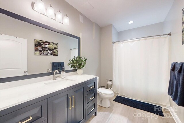 118 Tayport Dr, Troutman, NC 28166 - full bathroom with vanity, toilet, and wood finished floors