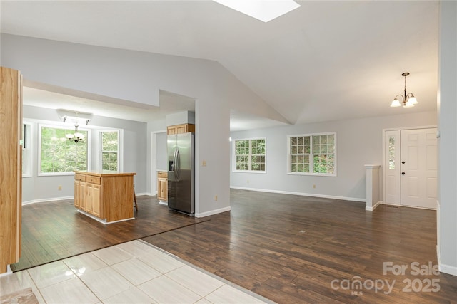 608 Surrey Glen Cir, Hendersonville, NC 28739 - unfurnished living room with a chandelier, dark wood finished floors, vaulted ceiling, and baseboards