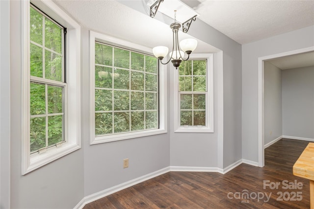 608 Surrey Glen Cir, Hendersonville, NC 28739 - unfurnished dining area with a chandelier, dark wood-type flooring, and baseboards