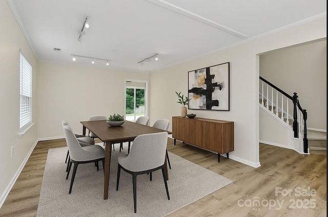 720 Reigate Rd, Charlotte, NC 28262 - dining room with plenty of natural light, light wood-type flooring, crown molding, and track lighting