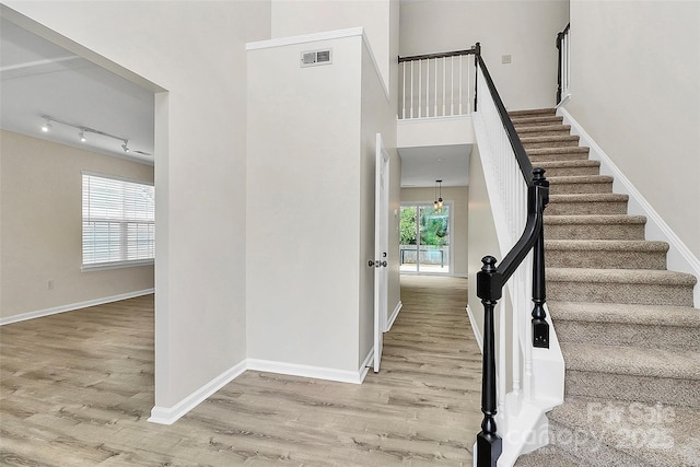 720 Reigate Rd, Charlotte, NC 28262 - staircase featuring wood finished floors and a towering ceiling
