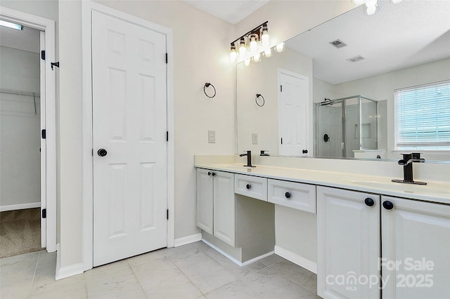 720 Reigate Rd, Charlotte, NC 28262 - full bathroom featuring a stall shower, double vanity, a spacious closet, and marble finish flooring