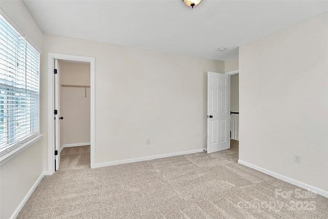720 Reigate Rd, Charlotte, NC 28262 - unfurnished bedroom featuring light carpet and a spacious closet