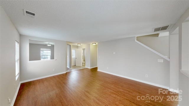 8139 Deodora Cedar Ln, Charlotte, NC 28215 - unfurnished room with wood finished floors, baseboards, and a textured ceiling