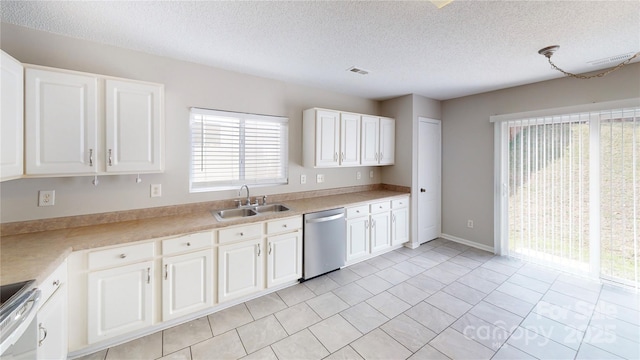 8139 Deodora Cedar Ln, Charlotte, NC 28215 - kitchen featuring appliances with stainless steel finishes, a sink, a textured ceiling, white cabinetry, and light countertops