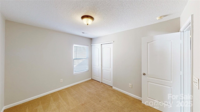 8139 Deodora Cedar Ln, Charlotte, NC 28215 - unfurnished bedroom with light colored carpet, a closet, baseboards, and a textured ceiling