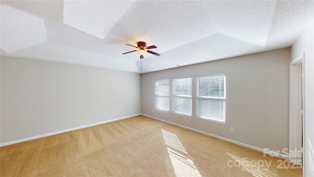8139 Deodora Cedar Ln, Charlotte, NC 28215 - unfurnished room with a tray ceiling, light colored carpet, a ceiling fan, baseboards, and a textured ceiling