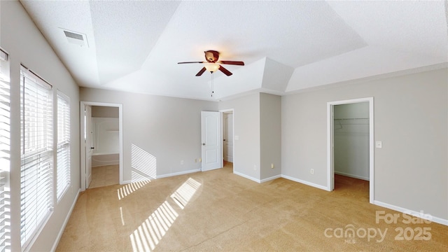 8139 Deodora Cedar Ln, Charlotte, NC 28215 - unfurnished bedroom with a walk in closet, light carpet, a closet, baseboards, and vaulted ceiling
