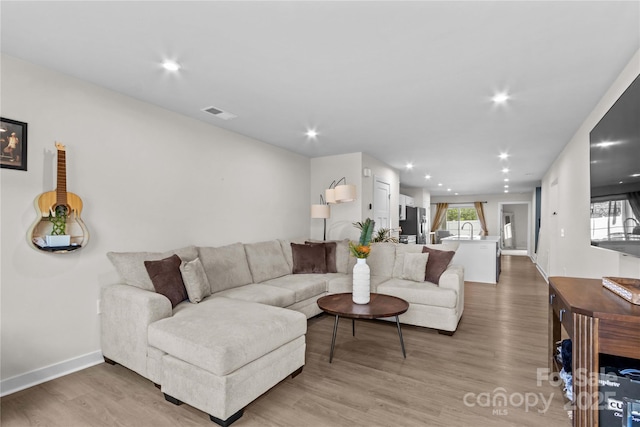 124 Kristin View Ln Unit C, Troutman, NC 28166 - living room featuring light wood-type flooring, recessed lighting, and baseboards