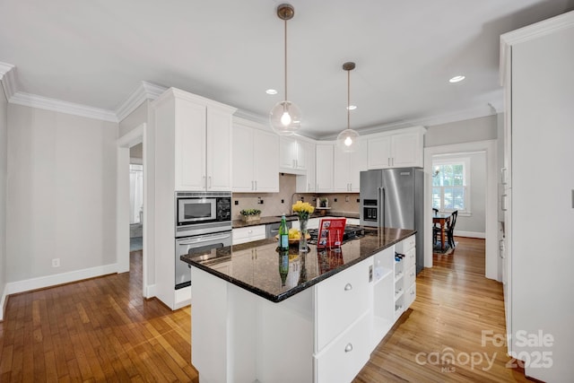 361 5th St NW, Hickory, NC 28601 - kitchen with stainless steel appliances, baseboards, white cabinetry, light wood-style flooring, and ornamental molding
