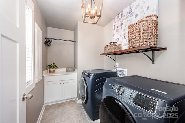 915 Claires Creek Ln, Davidson, NC 28036 - laundry room featuring washing machine and dryer, light tile patterned floors, a chandelier, and cabinet space