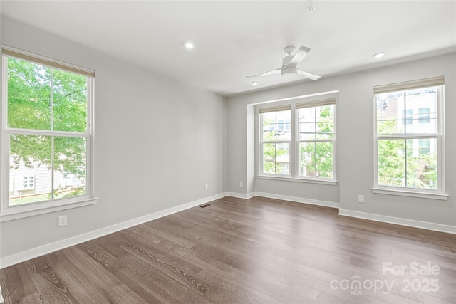 420 E 16th St, Charlotte, NC 28206 - empty room with healthy amount of natural light, dark wood finished floors, baseboards, a ceiling fan, and recessed lighting