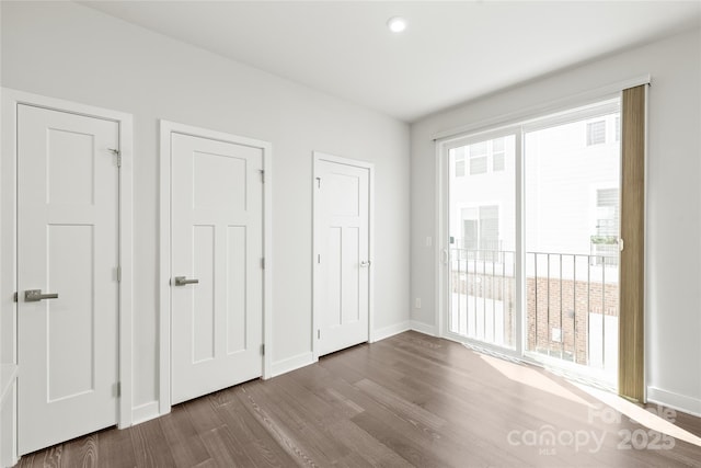 420 E 16th St, Charlotte, NC 28206 - unfurnished bedroom with dark wood finished floors, access to outside, and baseboards