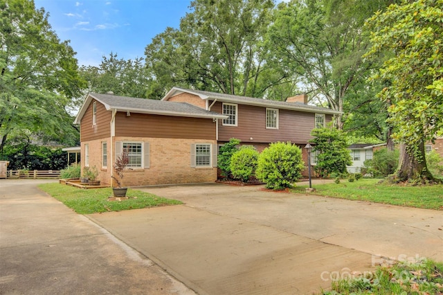 841 12th Ave NW, Hickory, NC 28601 - view of property exterior featuring concrete driveway, a chimney, and brick siding