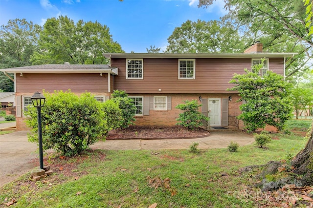 841 12th Ave NW, Hickory, NC 28601 - view of front of home with a chimney, brick siding, and a patio area