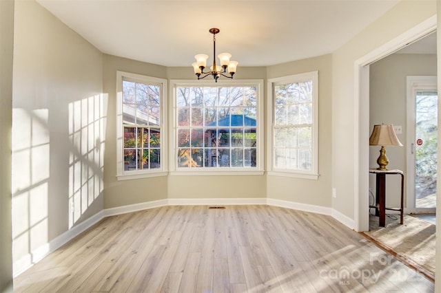 841 12th Ave NW, Hickory, NC 28601 - unfurnished dining area featuring wood finished floors, a chandelier, and baseboards
