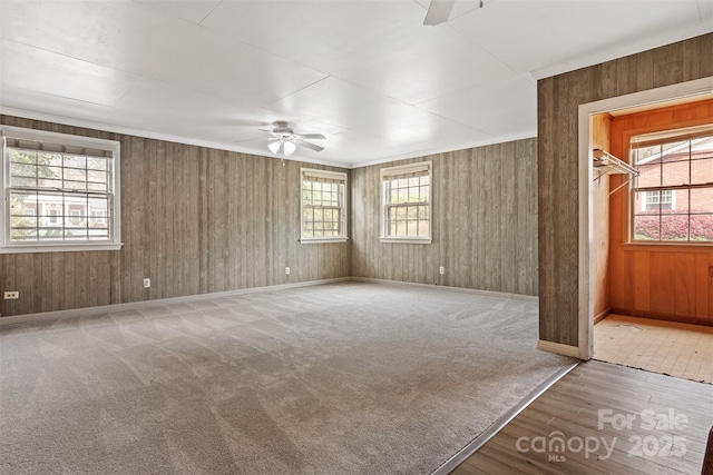 841 12th Ave NW, Hickory, NC 28601 - unfurnished room featuring ceiling fan, wood finished floors, baseboards, wood walls, and crown molding