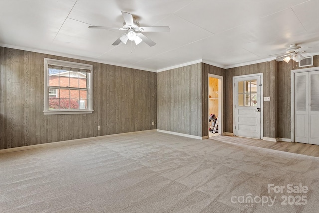 841 12th Ave NW, Hickory, NC 28601 - carpeted spare room with a ceiling fan, crown molding, baseboards, and wooden walls