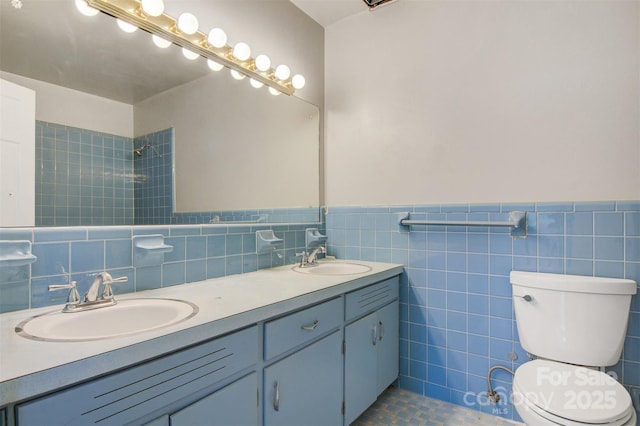 841 12th Ave NW, Hickory, NC 28601 - bathroom featuring tile walls, double vanity, toilet, tiled shower, and a wainscoted wall