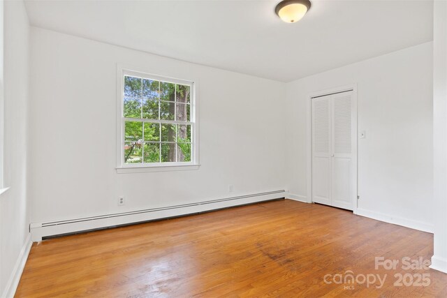 841 12th Ave NW, Hickory, NC 28601 - unfurnished room featuring a baseboard radiator, wood finished floors, and baseboards