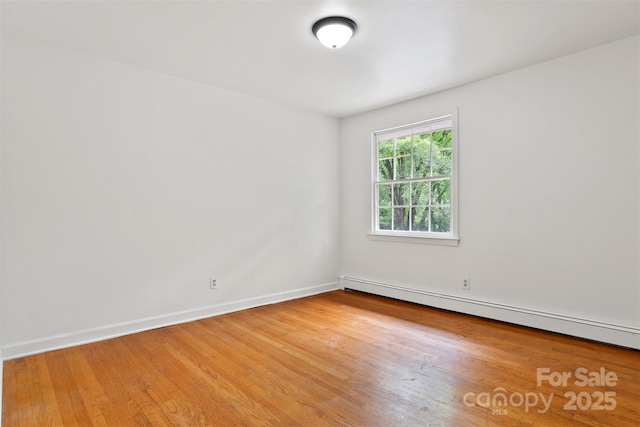 841 12th Ave NW, Hickory, NC 28601 - spare room with baseboard heating, wood finished floors, and baseboards