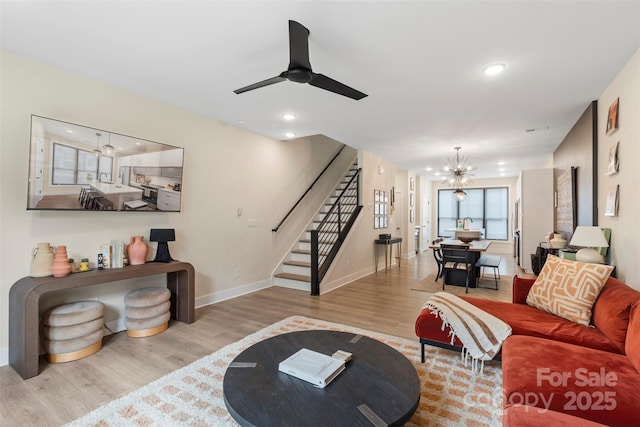 4520 Radler Ct, Charlotte, NC 28217 - living area featuring stairs, wood finished floors, a chandelier, a ceiling fan, and recessed lighting