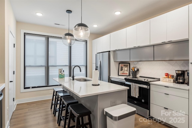 4520 Radler Ct, Charlotte, NC 28217 - kitchen with stainless steel appliances, a sink, tasteful backsplash, a kitchen breakfast bar, and light countertops