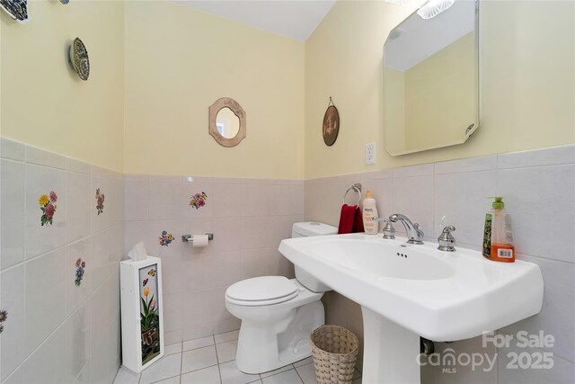 229 Hubbard Hollow Rd, Rosman, NC 28772 - half bathroom with tile walls, a wainscoted wall, and tile patterned flooring