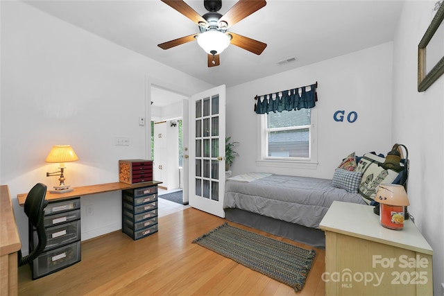 229 Hubbard Hollow Rd, Rosman, NC 28772 - bedroom featuring light wood-style floors, french doors, an office area, and ceiling fan