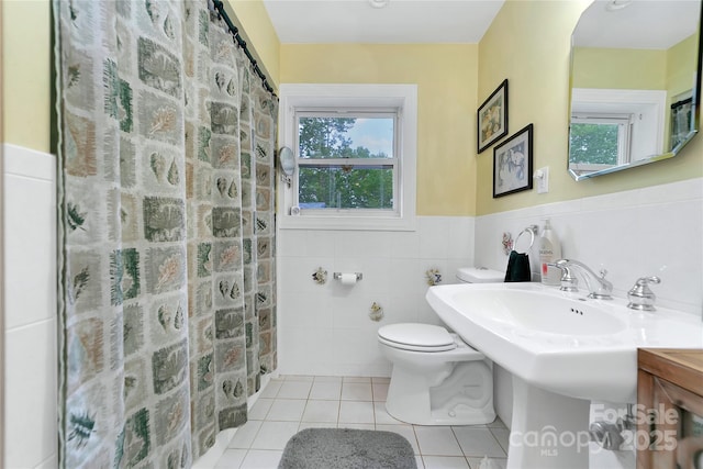 229 Hubbard Hollow Rd, Rosman, NC 28772 - bathroom with tile patterned flooring, tile walls, a wainscoted wall, and a shower with shower curtain