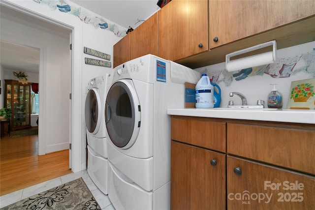 229 Hubbard Hollow Rd, Rosman, NC 28772 - washroom featuring separate washer and dryer, cabinet space, and light tile patterned floors