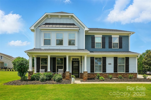 7322 Vesper Dr, Huntersville, NC 28078 - craftsman-style house with a front yard, a porch, board and batten siding, and a shingled roof