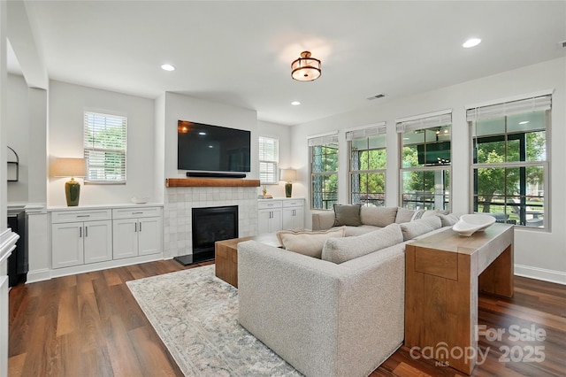 7322 Vesper Dr, Huntersville, NC 28078 - living area with a tiled fireplace, dark wood-style floors, and recessed lighting