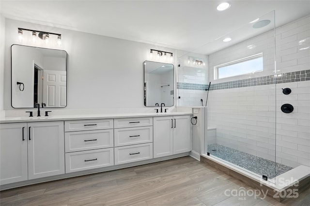7322 Vesper Dr, Huntersville, NC 28078 - bathroom with double vanity, a walk in shower, recessed lighting, and wood finished floors