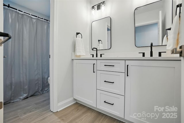 7322 Vesper Dr, Huntersville, NC 28078 - full bathroom with wood finished floors, double vanity, and curtained shower