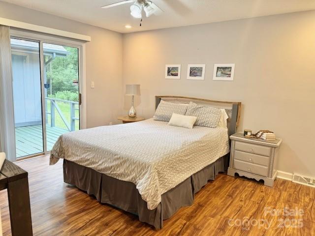 7133 Tall Tree Ln, Charlotte, NC 28214 - bedroom with access to outside, wood finished floors, recessed lighting, a ceiling fan, and baseboards