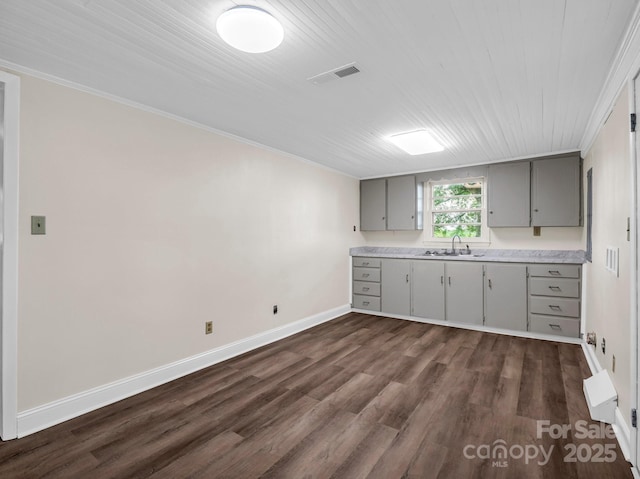 226 Dobbins Rd, Ellenboro, NC 28040 - kitchen featuring gray cabinets, a sink, light countertops, dark wood-style floors, and baseboards