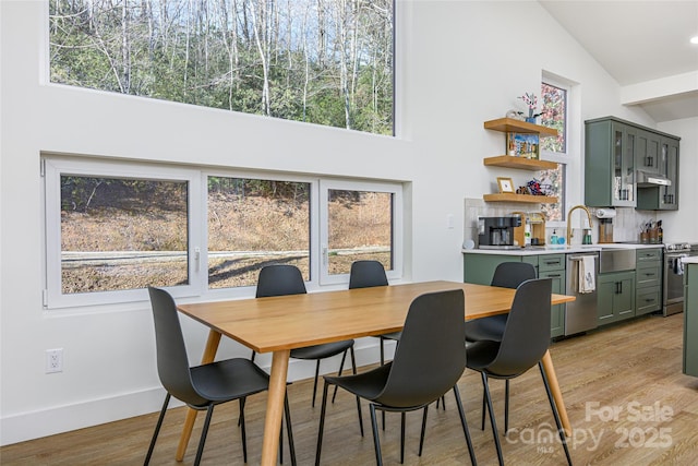 75 S Fork Trl, Lake Toxaway, NC 28747 - dining room with high vaulted ceiling, light wood-type flooring, and baseboards