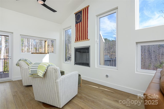 75 S Fork Trl, Lake Toxaway, NC 28747 - living area featuring a ceiling fan, wood finished floors, high vaulted ceiling, baseboards, and a glass covered fireplace